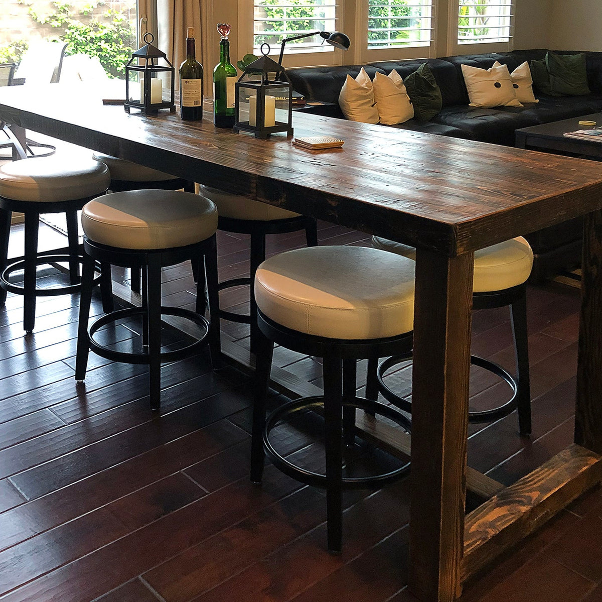 Experience timeless craftsmanship with this handcrafted Sequoia reclaimed wood bar-height table, paired with four white-cushioned stools. Ideal as a kitchen island or narrow restaurant table, showcasing sustainable materials and enduring quality.