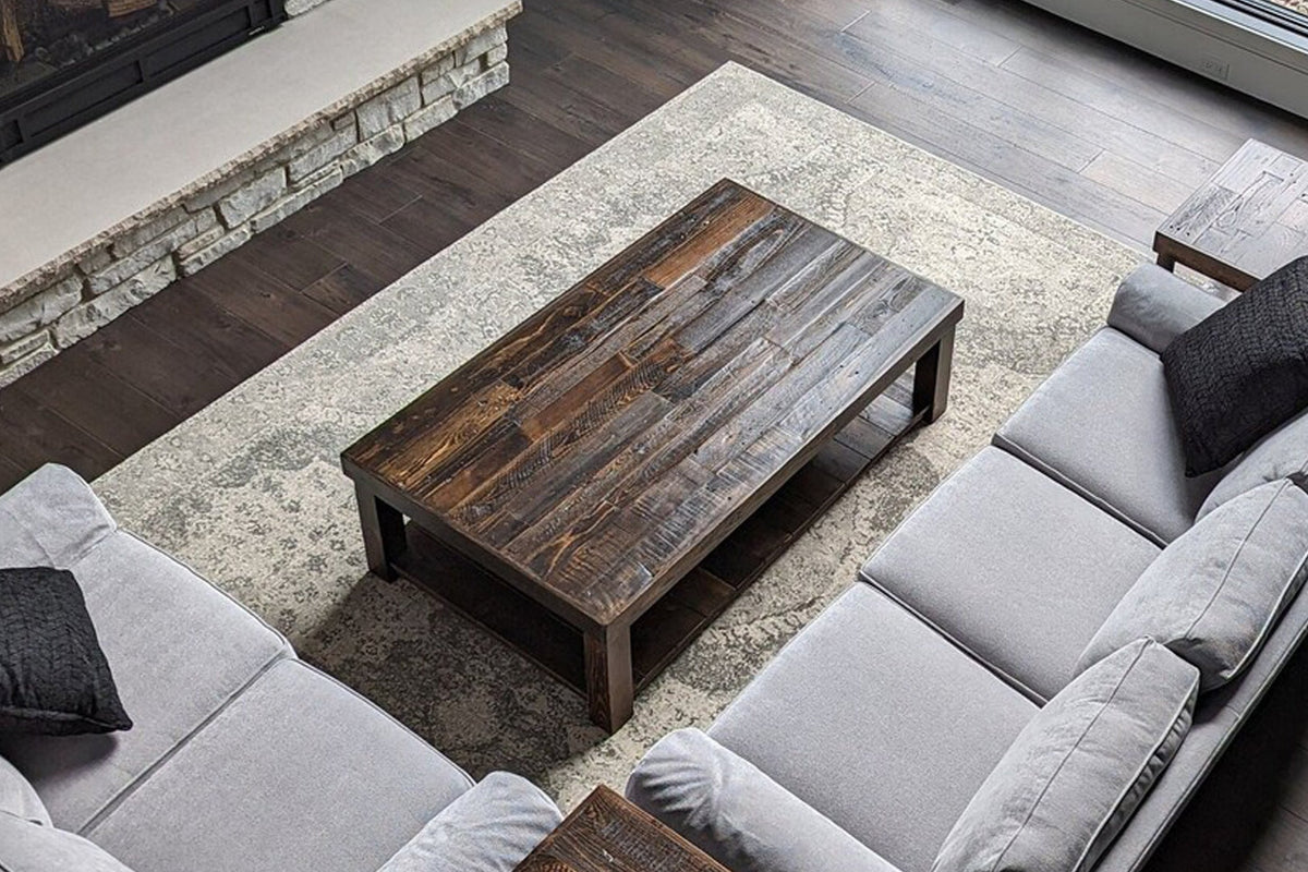 A modern living room with two light-gray sofas faces a handcrafted, customizable reclaimed wood coffee table in Espresso finish.