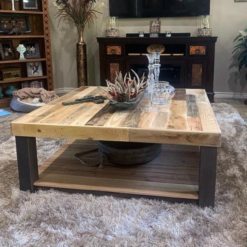 Natural finish square reclaimed wood coffee table in living room.