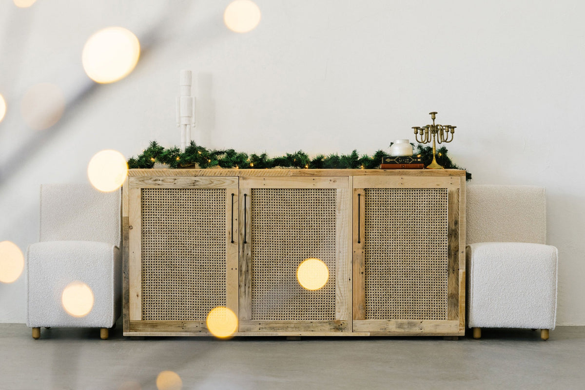 Experience timeless elegance with this handcrafted reclaimed wood sideboard, designed for enduring quality. Accented by festive garlands and artisan candles, this piece exemplifies sustainable furniture craftsmanship.
