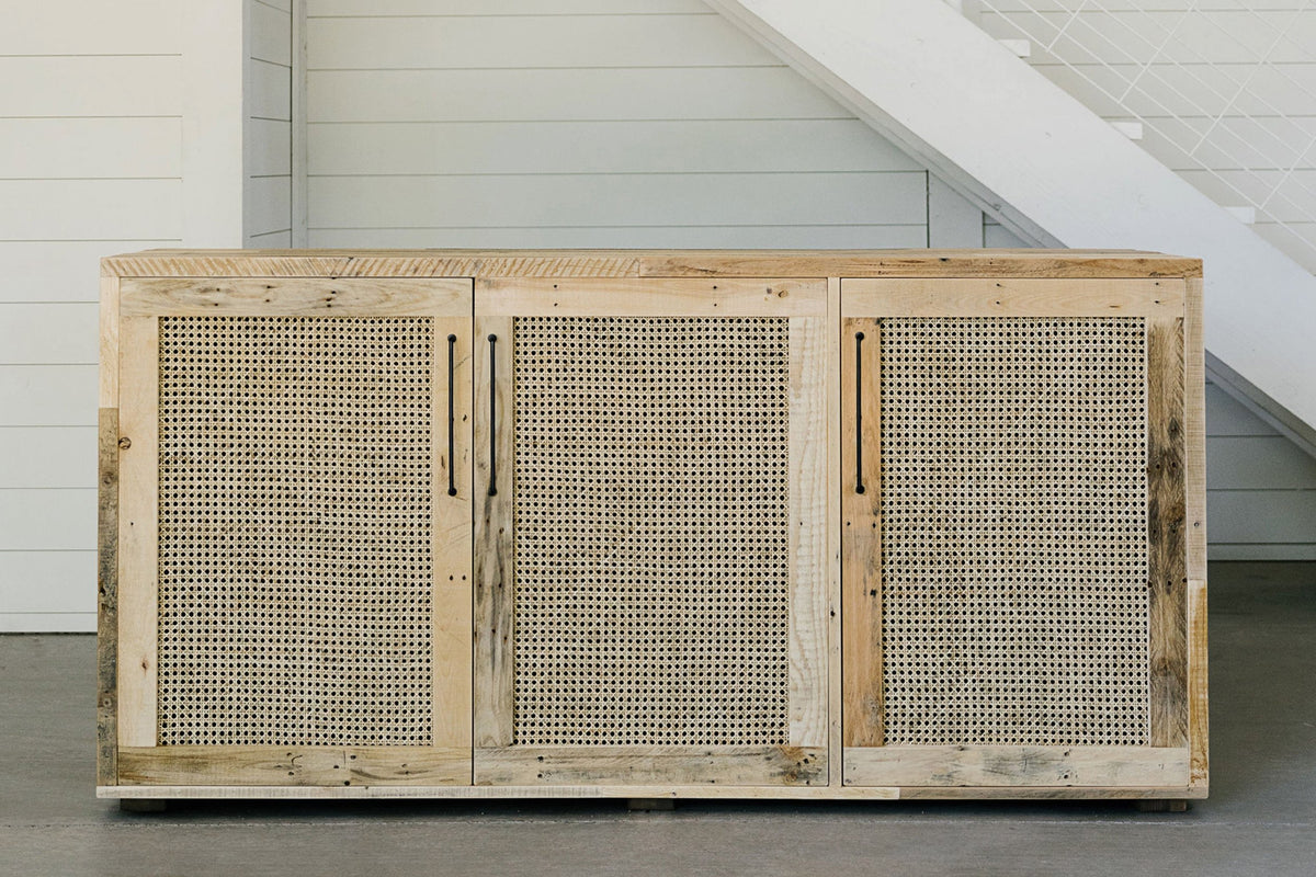 Expertly handcrafted in Arizona, this reclaimed wood sideboard features three cane door panels, offering enduring quality and sustainability. 