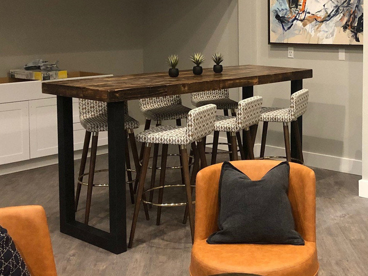 Experience timeless craftsmanship with this Arizona handcrafted bar height table, featuring a reclaimed wood top and sturdy steel u-shape legs. Patterned stools and leather chairs create inviting seating.