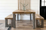 Reclaimed wood dining table with two benches in kitchen