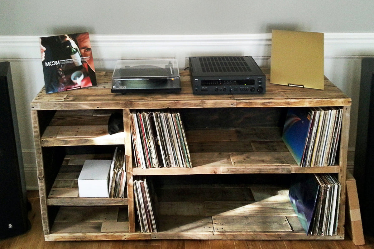 Handcrafted reclaimed wood vinyl record media console with a turntable, audio receiver, album shelves, and display cubbies.